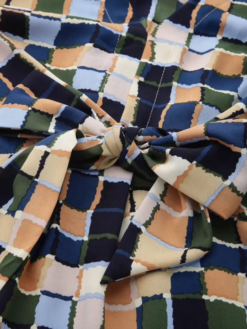 Printed Peplum Style Top With Front Tie And V-Neck